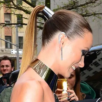 Olivia Wilde wears a sleek high ponytail with a silver metal tie