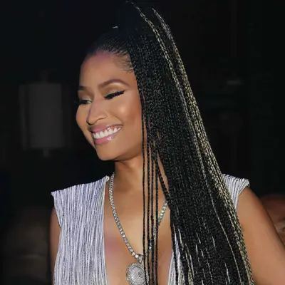 Nicki Minaj wears long box braids in a high ponytail with subtle highlights