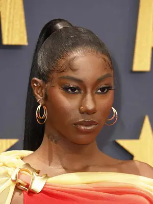 Flo Milli wearing a high ponytail with baby hair