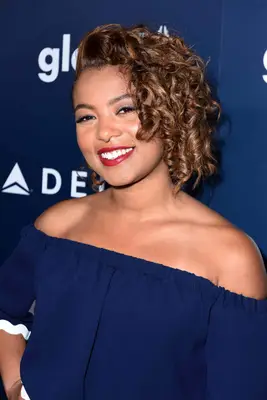 Jaz Sinclair with curly bronde highlighted ringlets