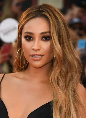 Shay Mitchell with long, caramel blonde-highlighted hair