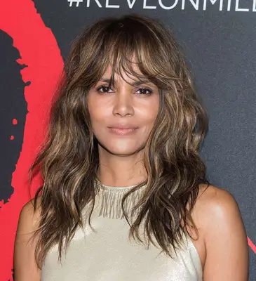 Halle Berry wavy brown hair and bangs with blonde highlights