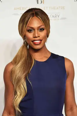 Laverne Cox updo with dark roots and sandy bronde mids and ends
