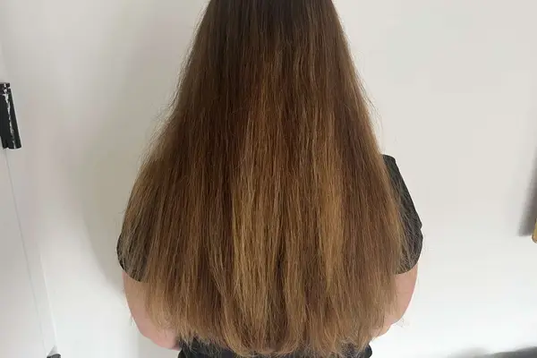 A person showing their hair before using the The Mane Label Hair Co. The Original Sway Heatless Curling Velour Ribbon