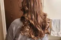 A person showing their hair after using the Mermade Hair Heatless Curls Kit