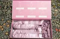 The Mermade Hair Heatless Curls Kit in its packgagin and on top of a patterned cloth