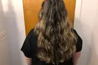 A person showing their hair after using the Halo Hair Labs Icy Halo Heatless Curling Kit