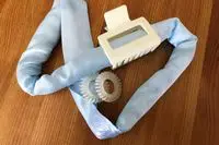 The Halo Hair Labs Icy Halo Heatless Curling Kit on a wooden table