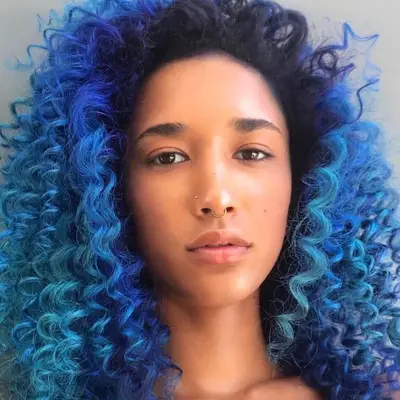 A model with teal curls