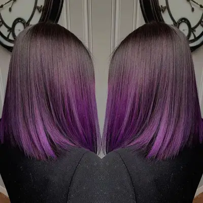 Mirror image of a sleek lob with purple highlights