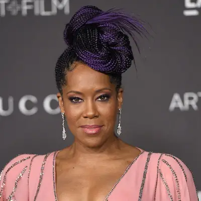 Regina King wears braids with purple highlights in a bun