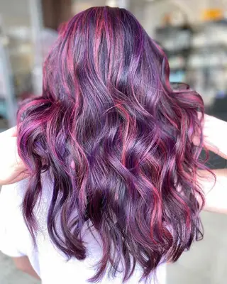 A woman with berry purple highlights