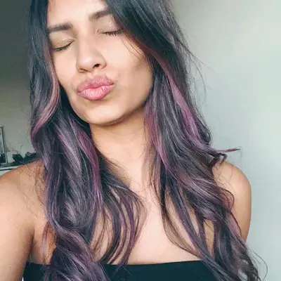 Woman with muted purple highlights