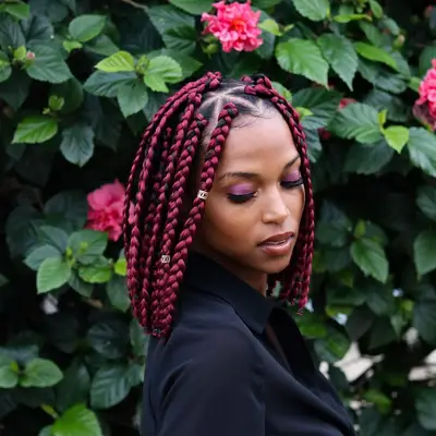 A woman with red box-braided long bob hairstyle