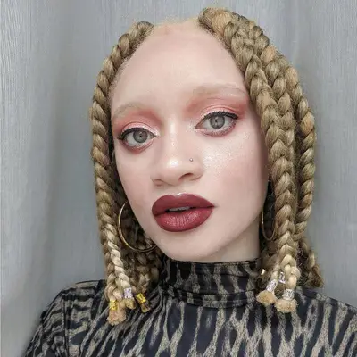 A woman with short, chunky blonde jumbo box braids