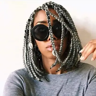 A woman with short, gray box braids