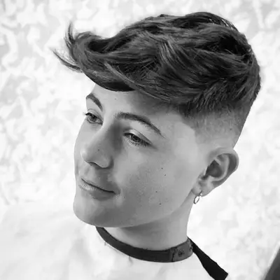 Man with long quiff 1950s-inspired hairstyle and single earring