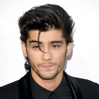 Zayn Malik wears a 1950s-inspired greaser hairstyle with one piece in front of face
