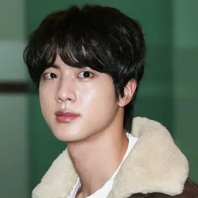 Jin wears a floppy mushroom fringe haircut