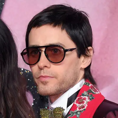 Jared Leto wears a rocker-style fringe haircut