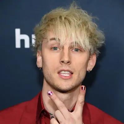 Machine Gun Kelly wears a messy, rock 