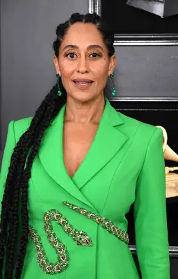 Tracee Ellis Ross wearing green blazer and jumbo side-swept braids on the red carpet