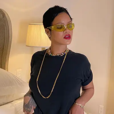 rihanna posing in hotel room with pixie cut 