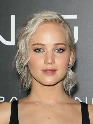 Jennifer Lawrence with a Long Pixie Cut that is wavy and worn in a half up style