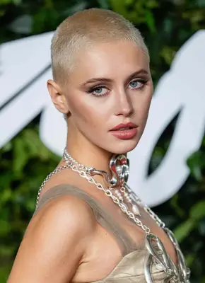 Iris Law with a bleach blonde buzz cut.