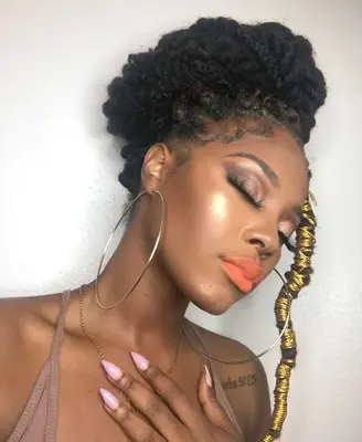 A woman with Marley twists in a statement bun