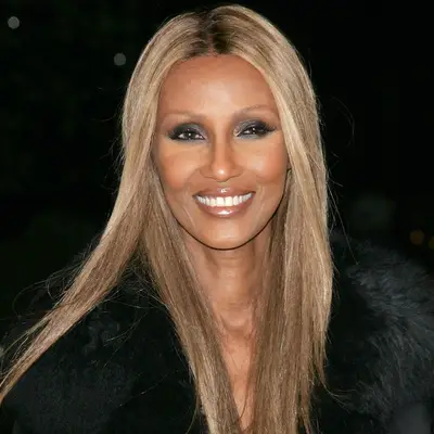 Iman wears long, straight champagne blonde hair