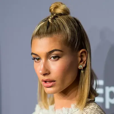 Hailey Bieber wears a long bob with half-up topknot