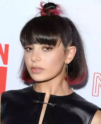 Charli XCX wears a half-up bun hairstyle