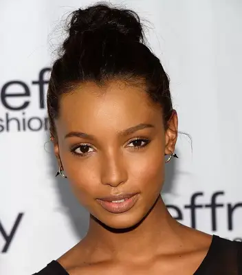 Jasmine Tookes wears a simple topknot hairstyle
