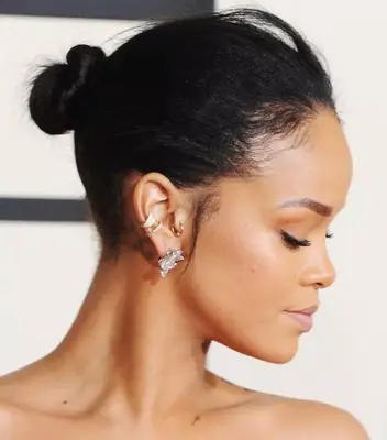 Rihanna wears a slicked-back bun with wispy pieces