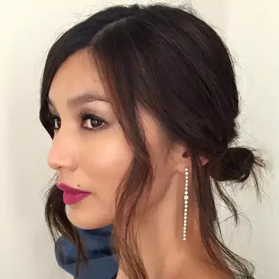 Gemma Chan wears a low messy bun hairstyle