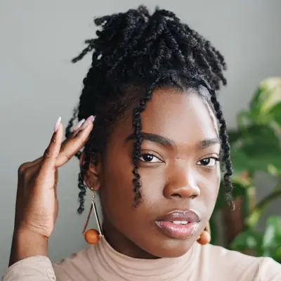 Woman wears mini twists in an updo hairstyle