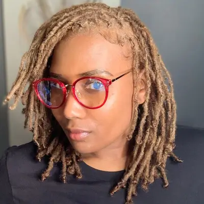 Woman wears blonde mini loc hairstyle