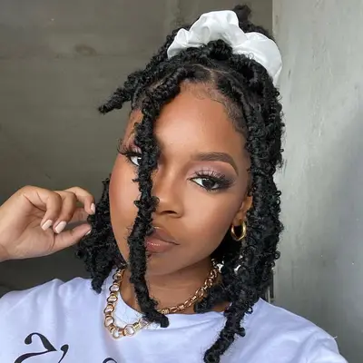 Woman wears butterfly loc hairstyle