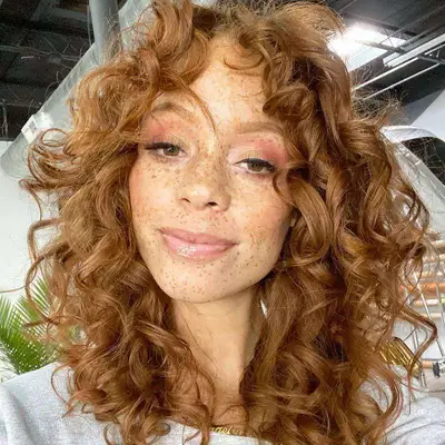 Woman with red, bouncy curls