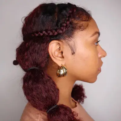 Woman with red banded pigtail hairstyle