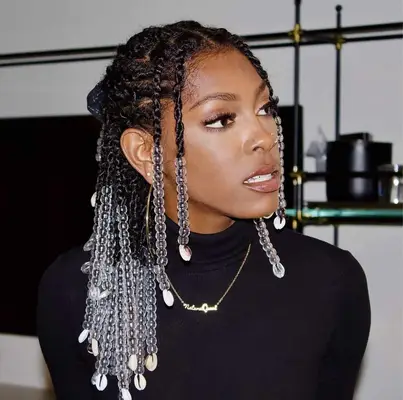 Woman wears beaded twists hairstyle