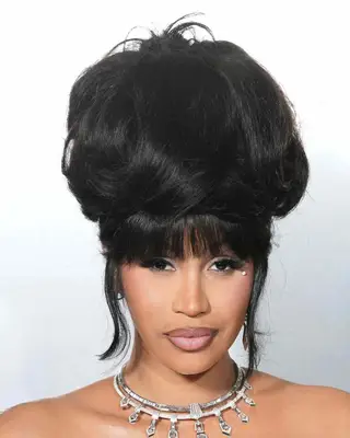 Cardi B with voluminous updo and bangs 