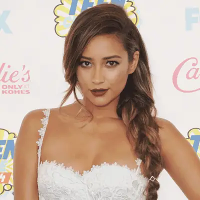 Shay Mitchell wearing a loose three-strand braid on the red carpet 