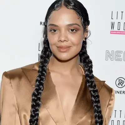 Tessa Thompson with two pigtail braids on the red carpet
