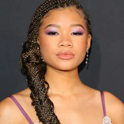 Storm Reid wearing cool, easy box braids in a large fishtail braid on the red carpet