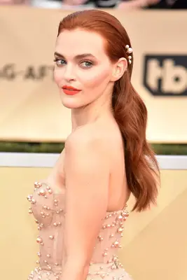 Madeline Brewer wears her romantic curls in a brushed back hairstyle