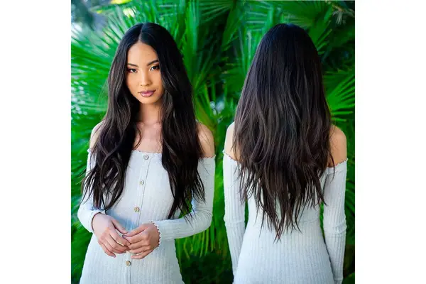 Front and back images of a person with hair extensions standing in front of a palm background