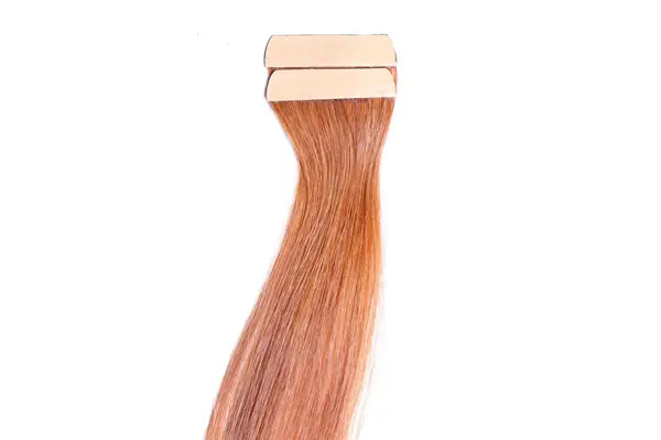 Indique Tape Hair Extensions in an auburn color