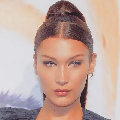 Bella Hadid wears a high ponytail with center parted front section